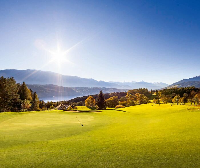 Golfplatz im strahlenden Sonnenschein See im Hintergrund