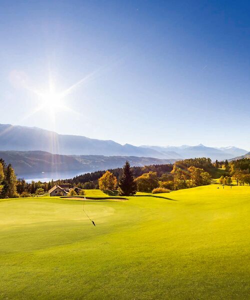 Golfplatz im strahlenden Sonnenschein See im Hintergrund